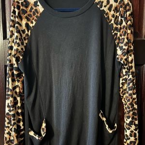 Black leopard long sleeve cotton top with leopard trim pockets.